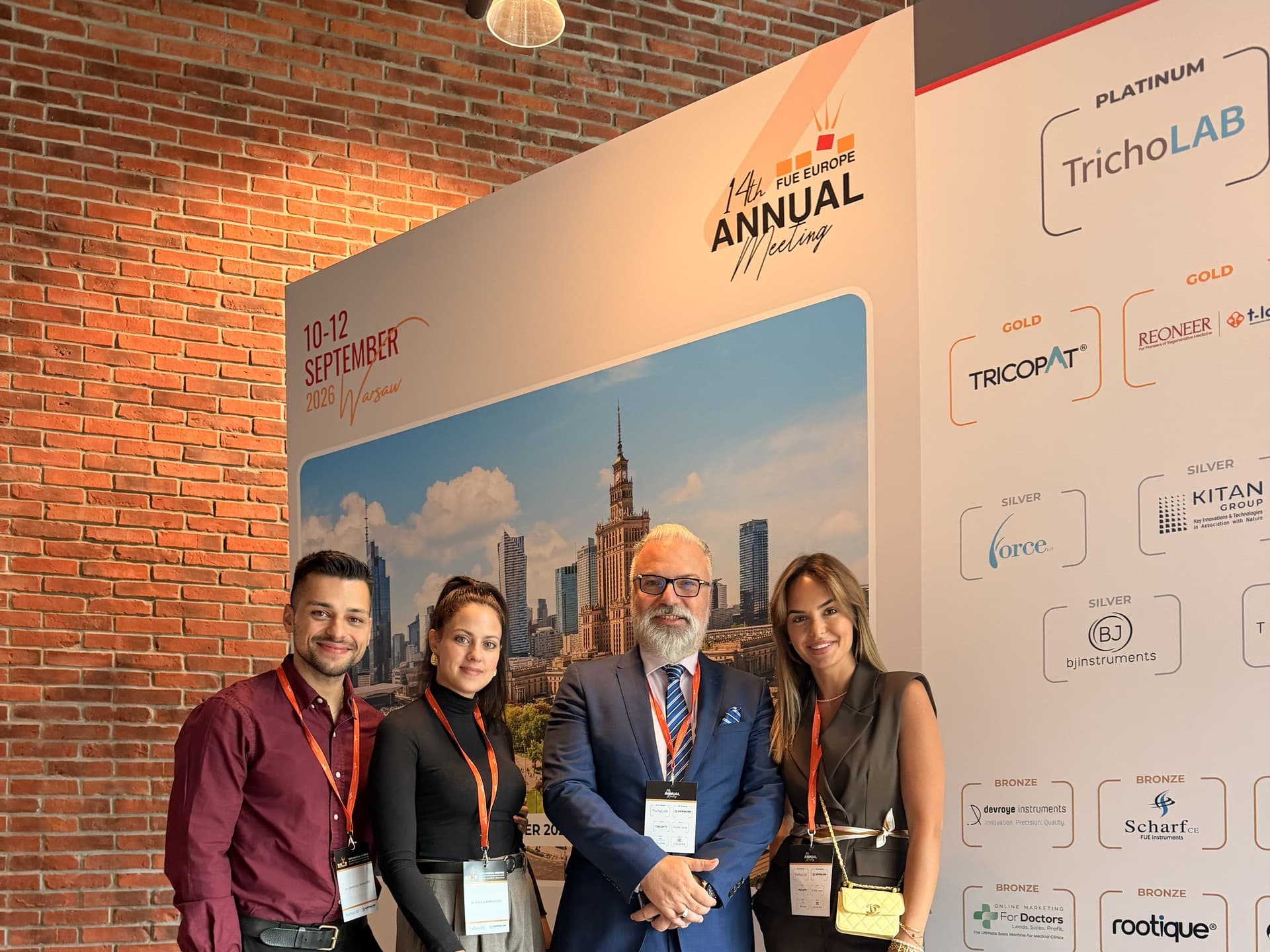 Advanced Hair Clinics team members in front of the FUE Europe 2026 conference backdrop in Warsaw