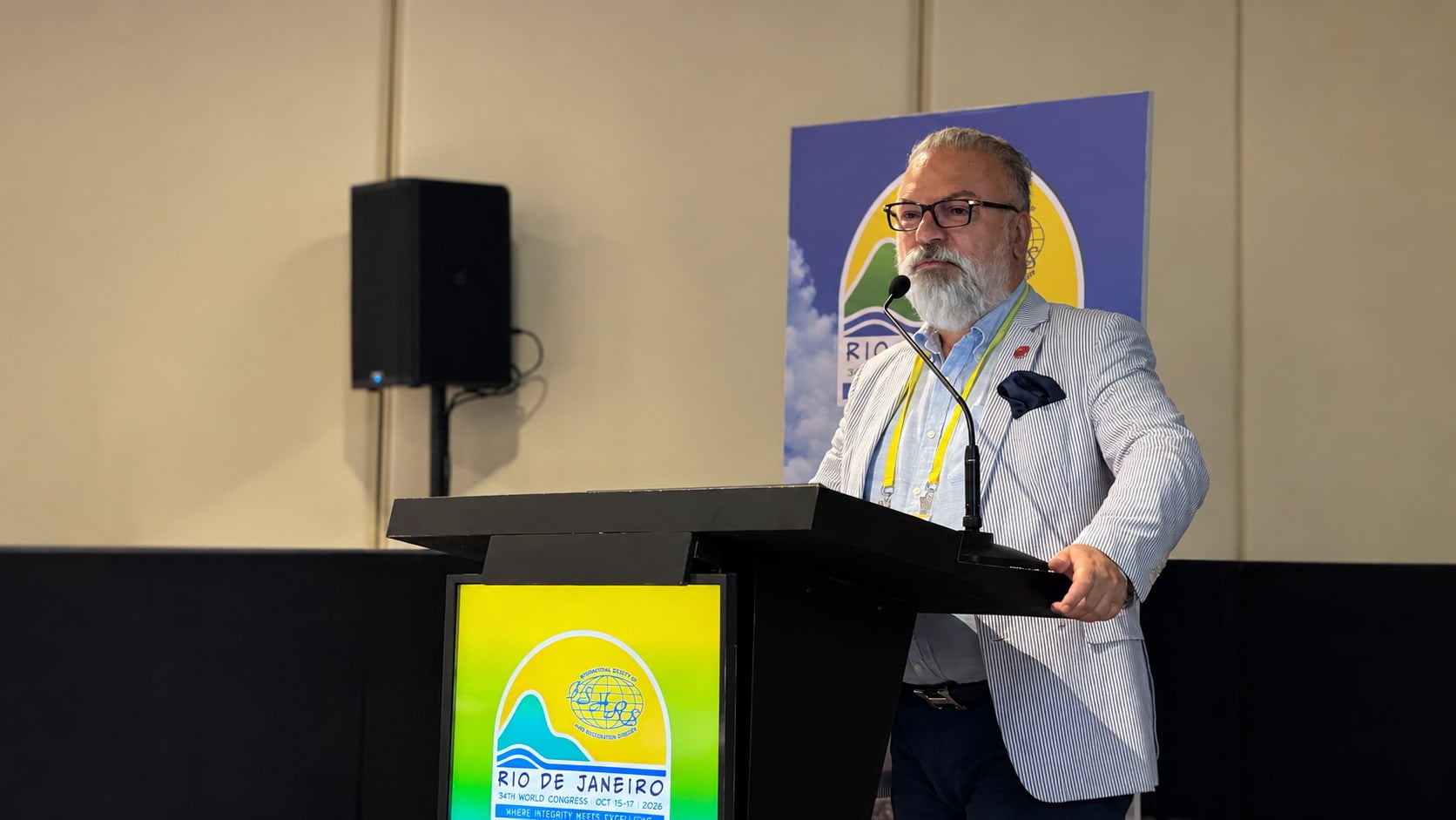 Dr. Anastasios Vekris at the podium during the 34th ISHRS World Congress in Rio de Janeiro.